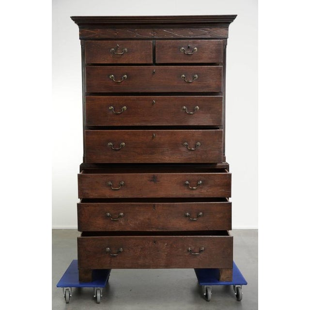 This antique English chest of drawers dates from the 18th century and is made of oak. The cabinet features intarsia inlay,...