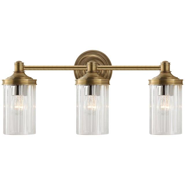 Ava Triple Sconce in Hand-Rubbed Antique Brass with Crystal Designer: Alexa Hampton Height: 9.25" Extension: 6" Backplate:...