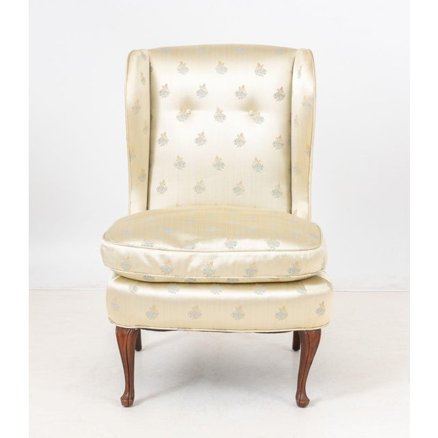 Floral Silk Upholstered Wingback Slipper Chair, on four cabriole legs. 37" H x 25" W x 22" D; seat: 19" H. Provenance:...
