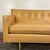 Mid Century Modern sofa by Edward Wormley for Dunbar Furniture. The sofa features a butterscotch tan leather with button...