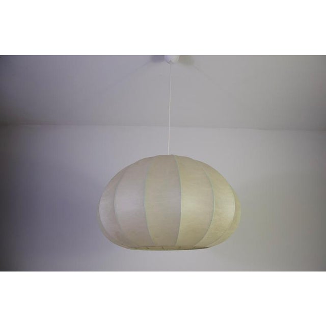 Mid-century round cocoon pendant lamp, italy, 1960s. This elegant vintage ceiling light features a softly rounded cocoon...
