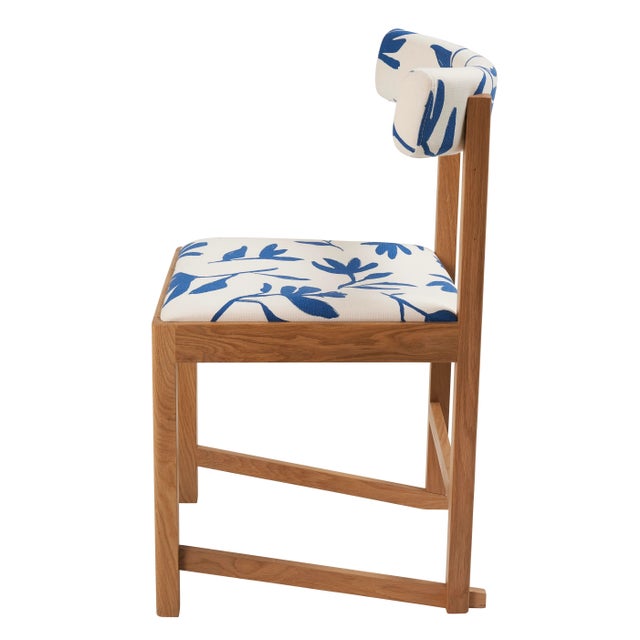 Combining an upholstered seat and back with the surprise of jauntily angled legs, the Mokki Dining Chair was designed by...