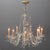 A vintage oversized Continental French chandelier offers chrome frame with nine s-scroll crystal arms terminating in...