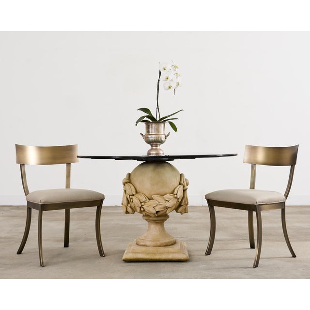 Modern bespoke set of four klismos dining chairs constructed from steel having a brushed lightly bronzed finish. The...