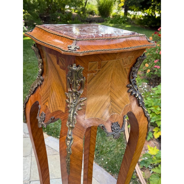 An elegant French Louis XV-style jardinière stand or pedestal, showcasing exquisite craftsmanship with beautifully...