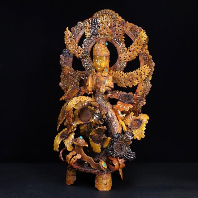 This is a monumental and highly intricate sculpture, masterfully carved to resemble translucent amber or aged horn. The...
