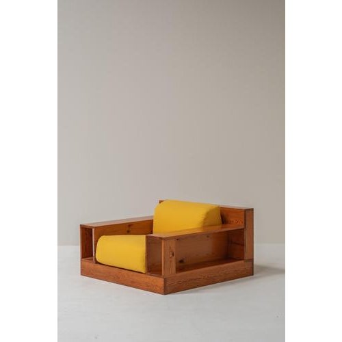 Striking Italian lounge chair from the 1970s, defined by its strong architectural wooden frame and low, relaxed...