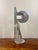 Created in 1977, this signed abstract sculpture by Beni Winkler brings together a broad crescent, architectural vertical...