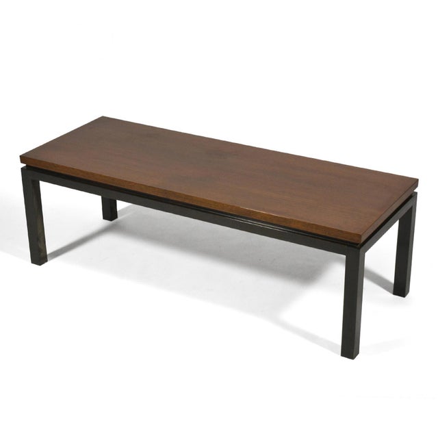 A simple form with subtle details, this coffee table attributed to Harvey Probber has a mahogany top which floats over the...