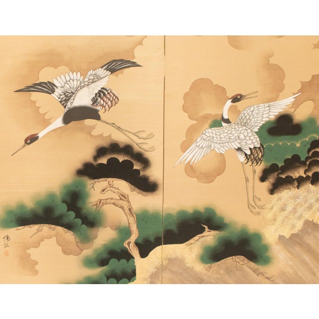 Large vintage Chinoiserie or Japanese Style 2-panel folding painted screen depicts two flying Red-Crowned Cranes above...