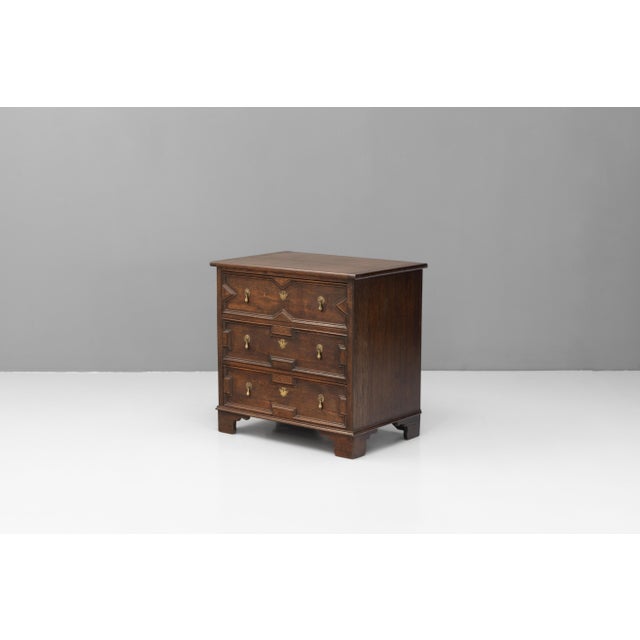 Reproduction Jacobean style small oak three drawer chest of drawers, fully restored with original brass mounts. Mitred...