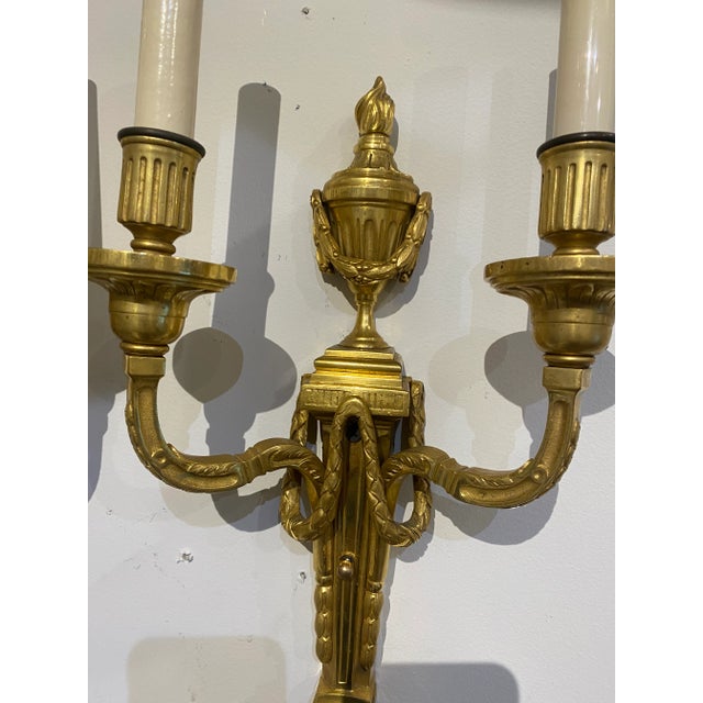 Pair of circa 1900’s Caldwell bronze sconces with 2 lights, neoclassic style. Original finish and patina.