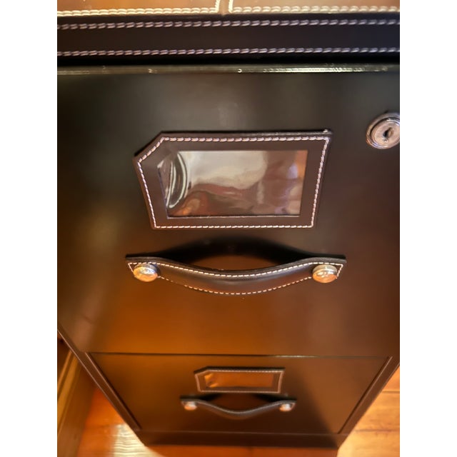 Handsome functional two drawer file cabinet wrapped in black leather with attractive contrasting white stitching. No key.