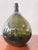 An exceptional and scarce 19th-century dark olive green glass bottle, hand-crafted in the distinctive "bladder onion"...