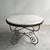 This impressive craftsman made Hollywood Regency, round marble dining or center table with a decorative steel base is...