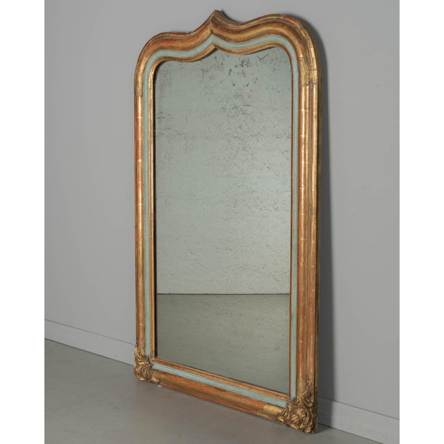 A 19th century French Louis Philippe Period gilded mirror. Unusual form with gently rounded top corners and distinct...