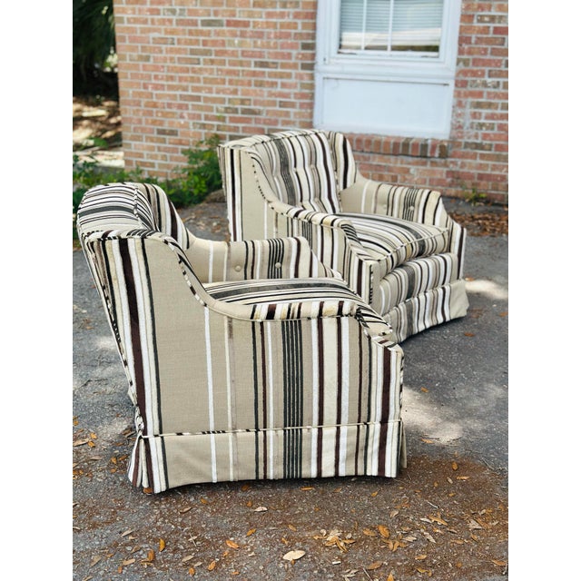 A stylish pair of vintage newly upholstered club chairs featuring tailored striped velvet fabric in soft neutral tones...