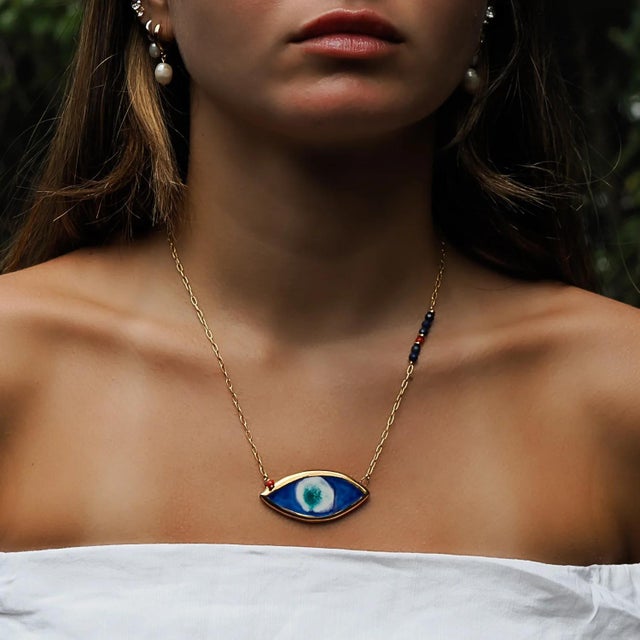 The Energy Anchor Evil Eye Pendant Necklace is a captivating blend of artisanal craftsmanship, symbolic protection, and...
