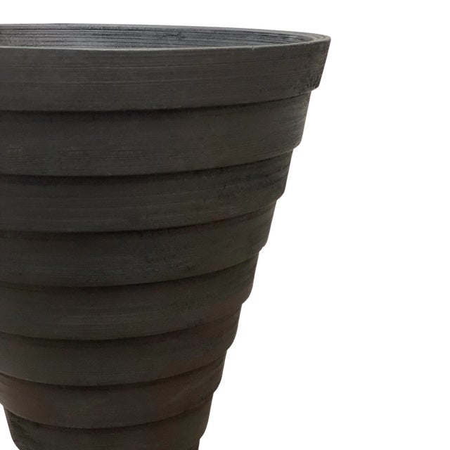 An oversized decorative vessel, turned from solid sections of wood laminated together into distinctive silhouettes....