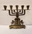 A beautifully crafted vintage brass menorah featuring intricate detailing and symbolic Judaic motifs. The piece includes...