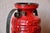 Bright red and proudly displayed in its black iron frame, this is a truly original German vase from the 1960s. It embodies...
