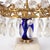 A charming pair of Swedish crystal prism candelabra featuring gilt brass mounts, white marble bases, and striking cobalt...