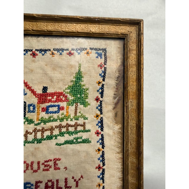 This vintage framed cross stitch wall art features a charming small house with the heartfelt quote, "Dear house, you are...