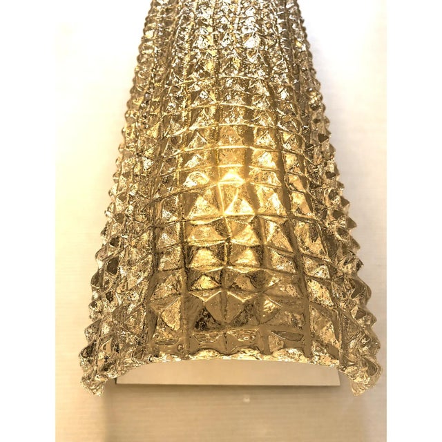 Luxury scenographic wall sconces in murano glass, with a crocodrile texture of glass tht make it sparkling even when the...