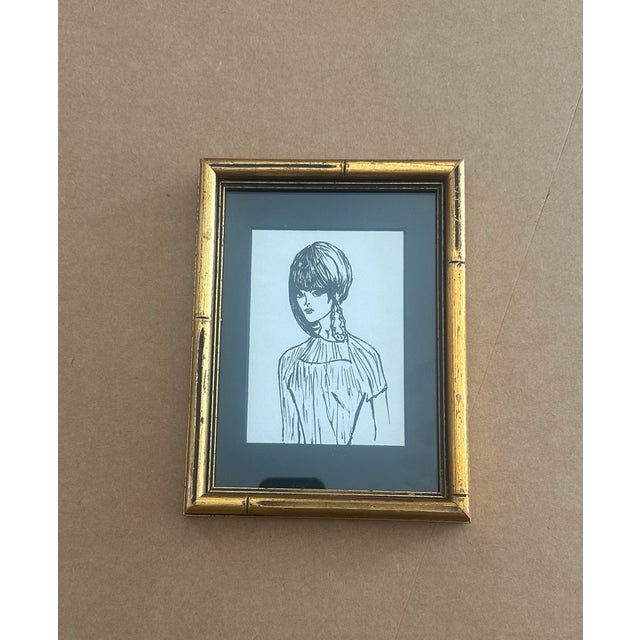 Striking ink portrait drawing of a young woman with a sculptural hairstyle and thoughtful expression. Rendered in bold,...