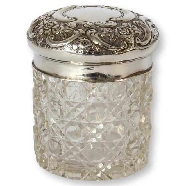A turn-of-the-century treasure from Chester, England, this cut crystal vanity jar features a beautifully repoussé sterling...