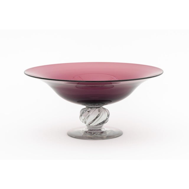 Three Amethyst Glass Tazzas, a pair of tall tazzae and a centerpiece bowl. Largest: 5.75" H x 12" Diameter. Provenance:...