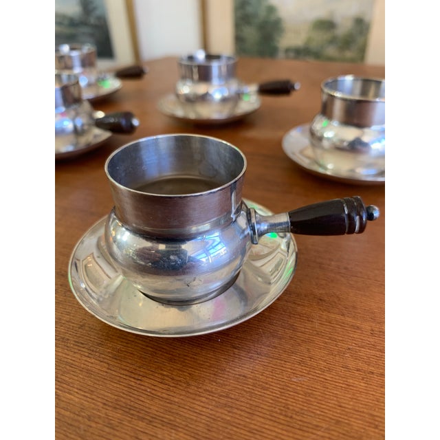 Charming vintage set of six silver-plated espresso cups with matching saucers, featuring elegant dark bakelite handles...