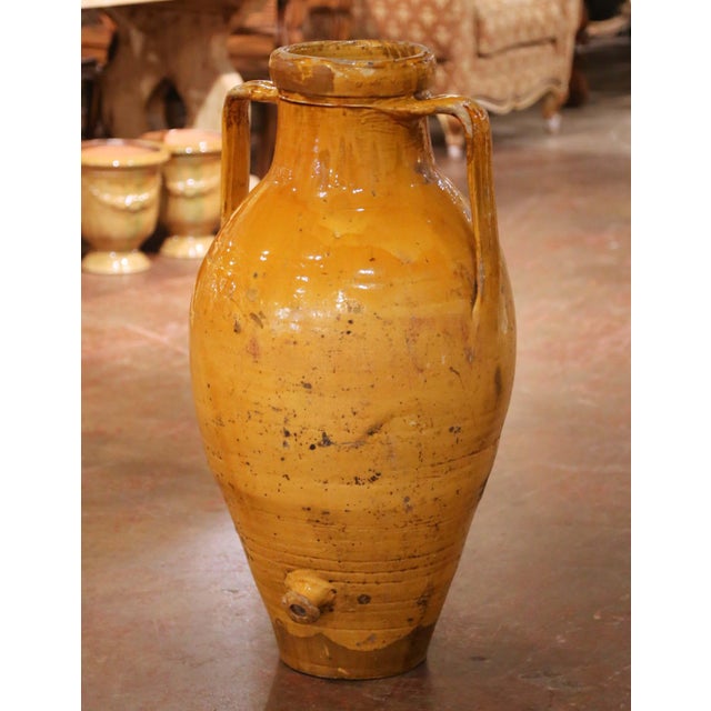 This impressive antique French glazed terracotta olive oil jar was crafted in Provence, Southern France, circa 1870....