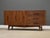 A mid century modern walnut credenza with sculpted pulls made by Young Furniture. Professionally refinished. Circa 1960....