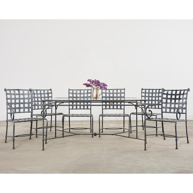 Weathered patio and garden dining suite made in the style and manner of Brown Jordan's Florentine collection. The set was...