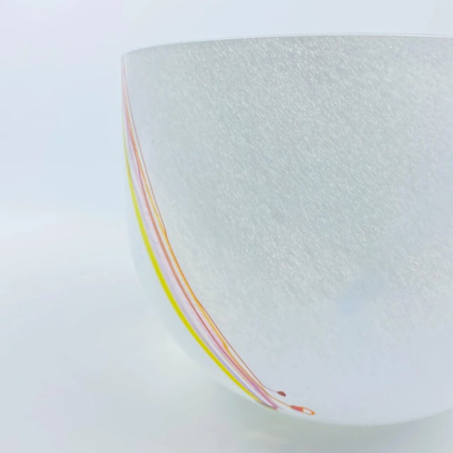 A large handcrafted decorative glass bowl with multicolored strands of glass to the sides. Designed and made by Bertil...