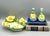 Elegant and unique set that consists of a tray and two bud vases. Each piece features hand crafted ceramic yellow roses...