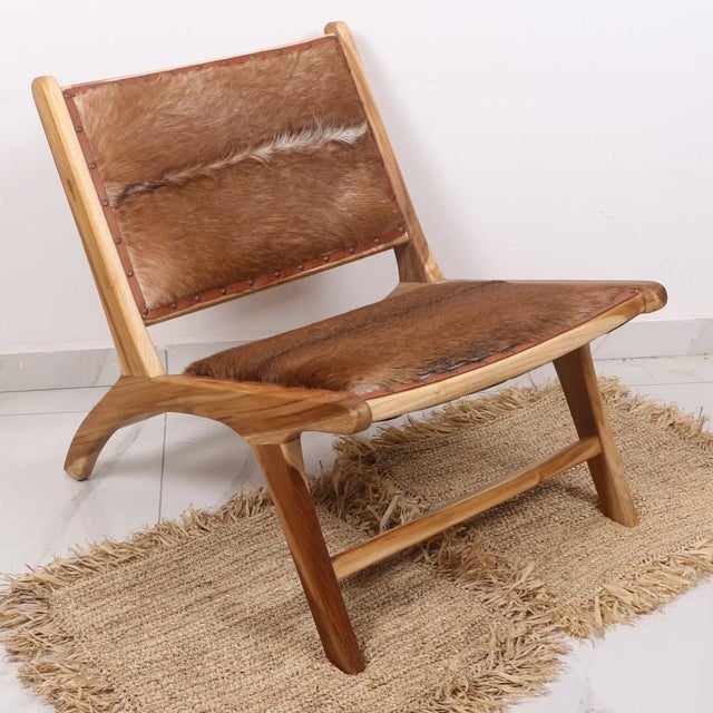 Our Natural Teak and Genuine Leather Chair is a masterpiece of artisanal craftsmanship, featuring a solid Teak wood frame...