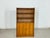 Beautiful vintage display cabinet from the 1960s. The tall cabinet impresses with its timeless mid-century design and a...