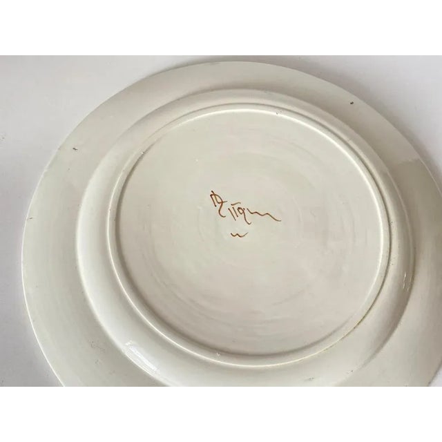 The dish is in faience. It has been made in Italy during the 19th century. The pattern decor is a rooster and the main...