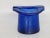 This lovely small ash tray is made of glass. This charming ashtray is in the shape of an upside-down top hat, with two...
