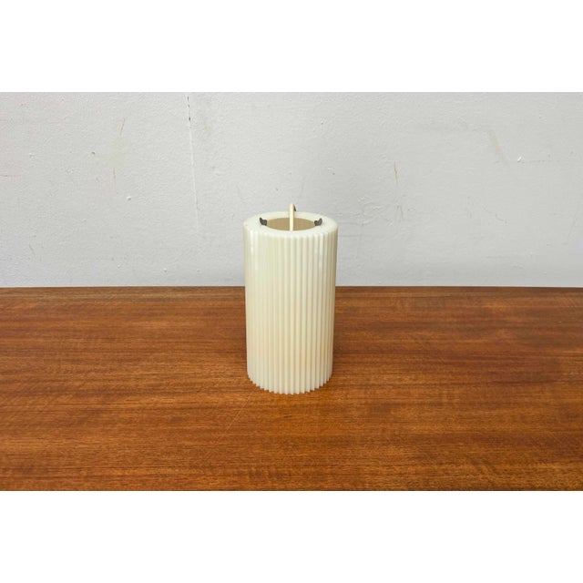 Mid-century pendant light by Erco. The cylindrical shades are made of translucent plastic and feature a ribbed surface....