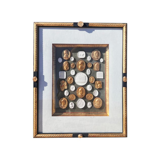 A classical arrangement with Grand tour revival white plaster and gilded cameo and intaglio arrangement. Around 33 fine...