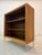 This elegant walnut bookcase from WK Möbel combines the refined aesthetics of mid-century design with a modern, floating...