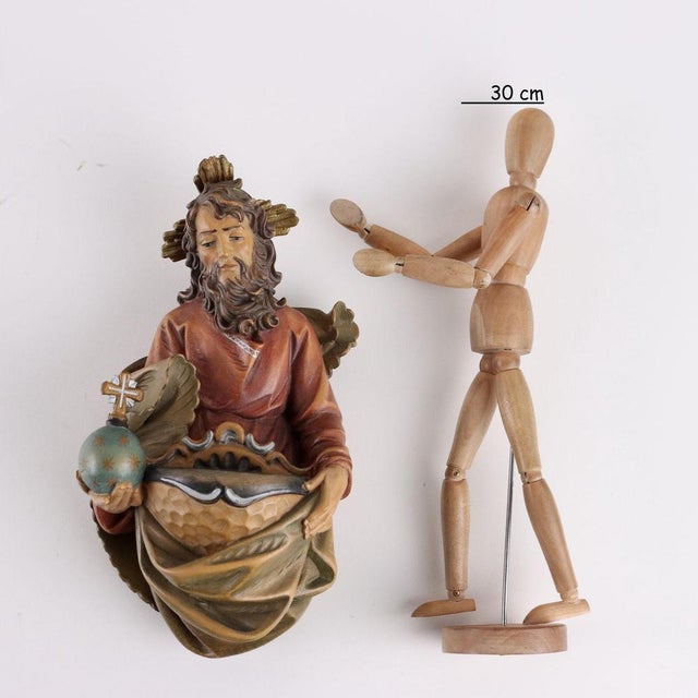 Carved, painted and gilded wooden stoup depicting God the Father. This piece is attributed to the mentioned...