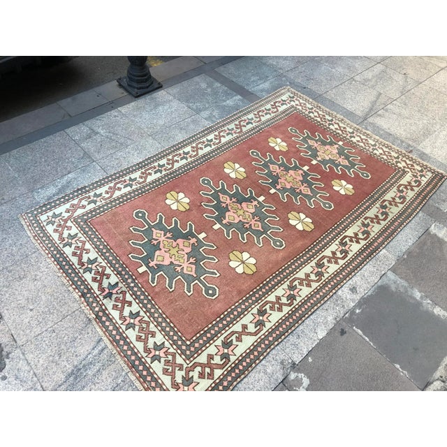 This is a vintage Turkish Oushak rug from the 1960s. The piece was hand-knotted.