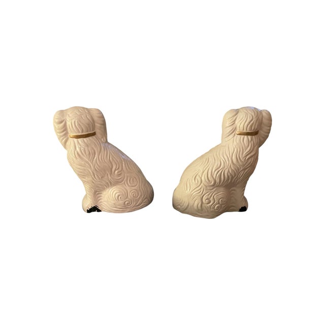 Large pair of white ceramic Staffordshire style spaniel dog figurines. White with black accents and painted gold collars....