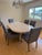 This Mid-Century modern dinning set consists of an adjustable size table in signature lacquered goatskin was purchased...
