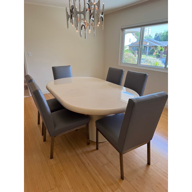 This Mid-Century modern dinning set consists of an adjustable size table in signature lacquered goatskin was purchased...