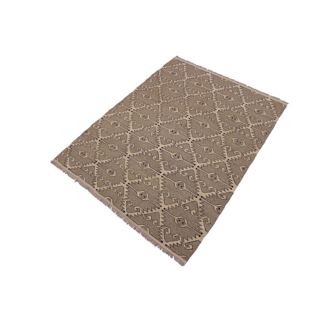 "Add a touch of elegance to your home with this casual chic hand woven Tribal Kilim Hand-Woven Wool Rug. Constructed on a...